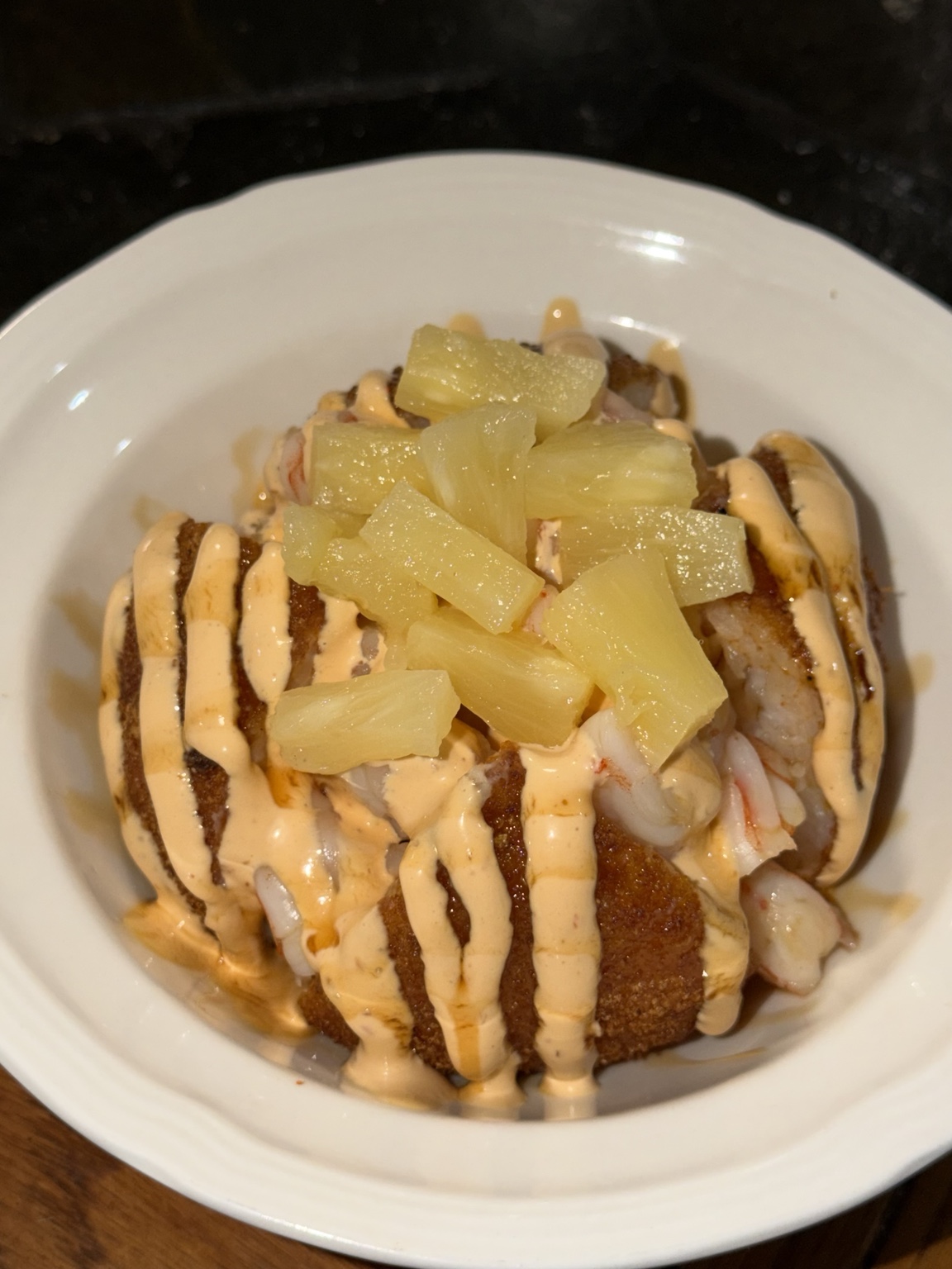 ONI Shrimp rice ball topped with pineapple and creamy chipotle sauce